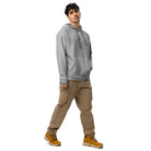 Man wearing Under Armour x Signature embroidered hoodie and brown cargo pants styled with yellow boots