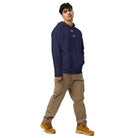 Man wearing Under Armour® x Signature embroidered hoodie in navy blue with khaki cargo pants and brown boots.