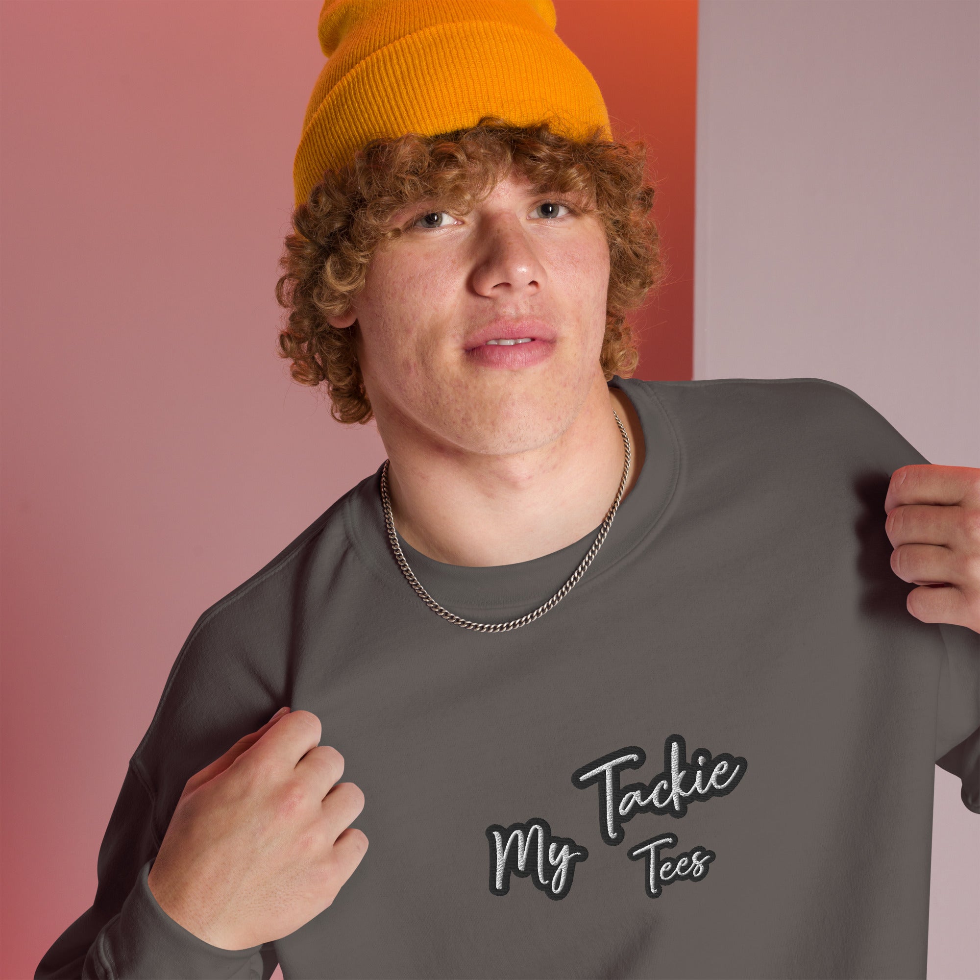 Close-up of My Tackie Tees embroidered logo on men's sweatshirt chest