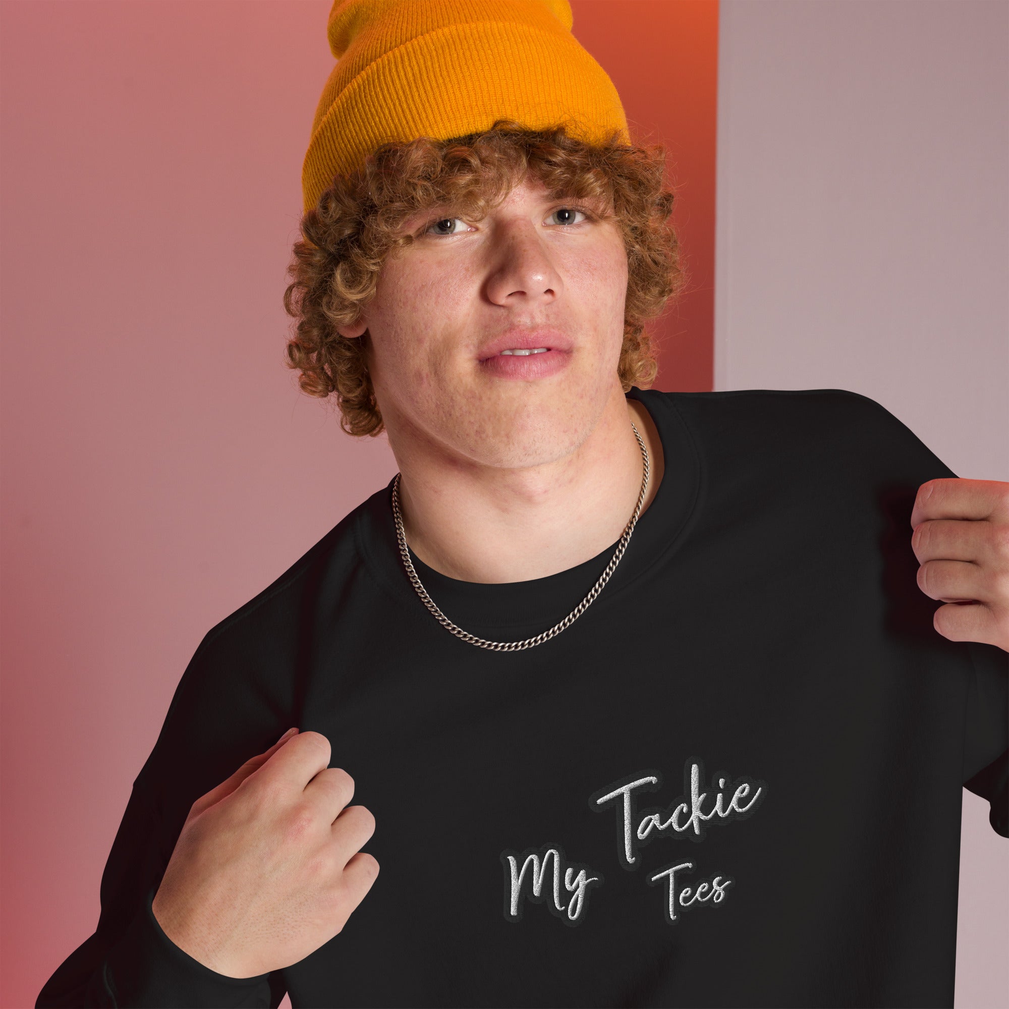 Close-up of My Tackie Tees embroidered logo on men's sweatshirt chest
