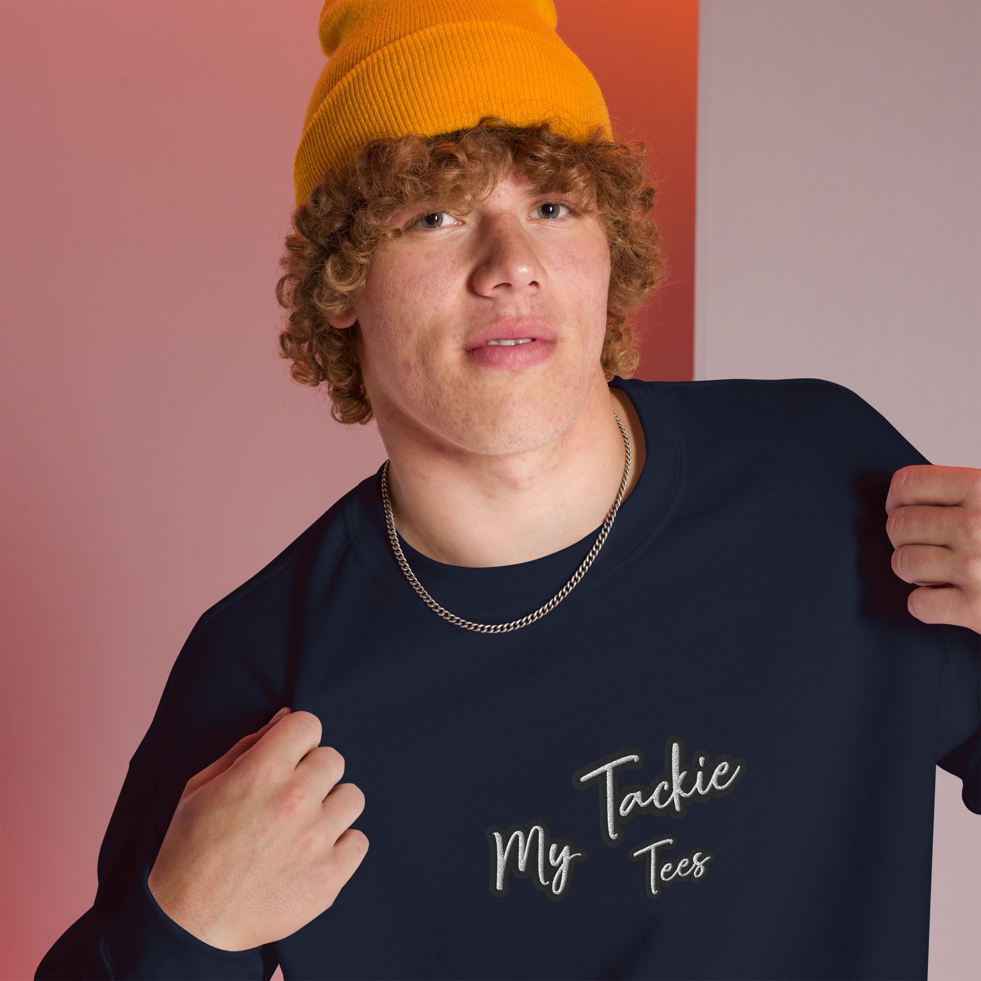 Close-up of My Tackie Tees embroidered logo on men's sweatshirt chest
