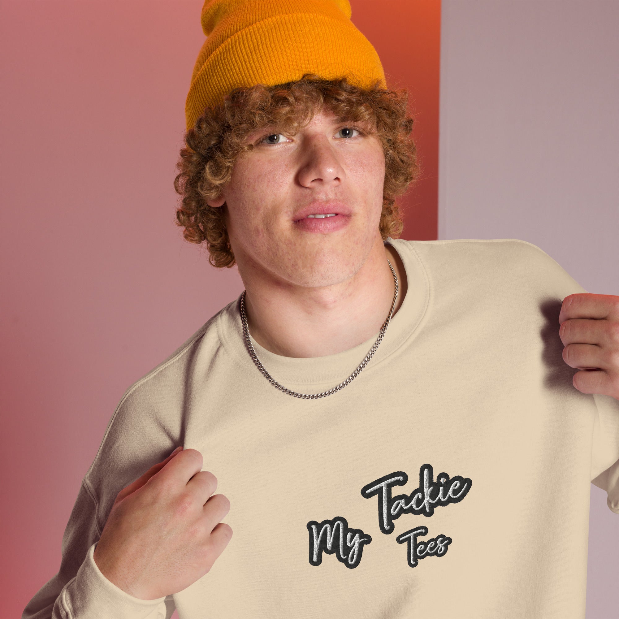 Close-up of My Tackie Tees embroidered logo on men's sweatshirt chest
